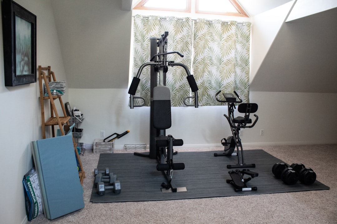 A well-equipped home gym featuring a sturdy weight bench, free weights, and exercise equipment in a bright, inviting space.