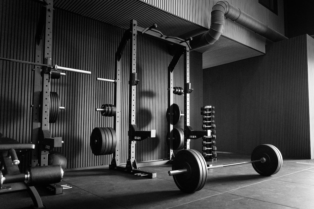 Empty gym with power rack, barbells, and weights
