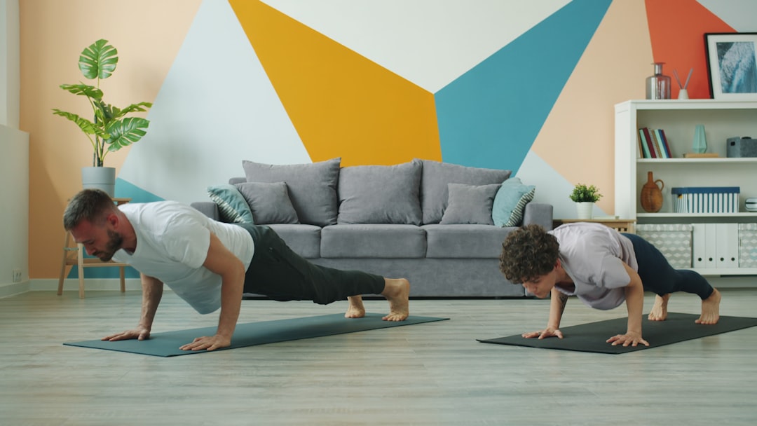 Man and woman doing push-ups on yoga mats