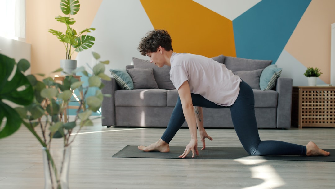 Woman doing yoga on a mat in a living room