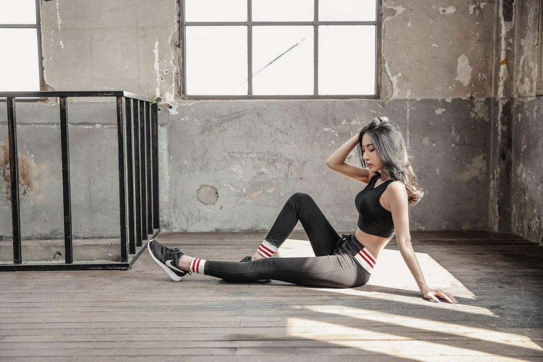 woman in black sports bra and black leggings doing yoga